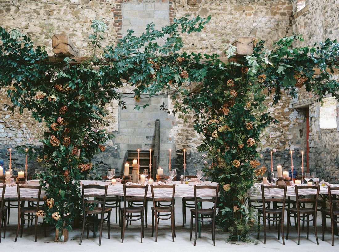 Romantic destination wedding reception table and arbor in Belgium